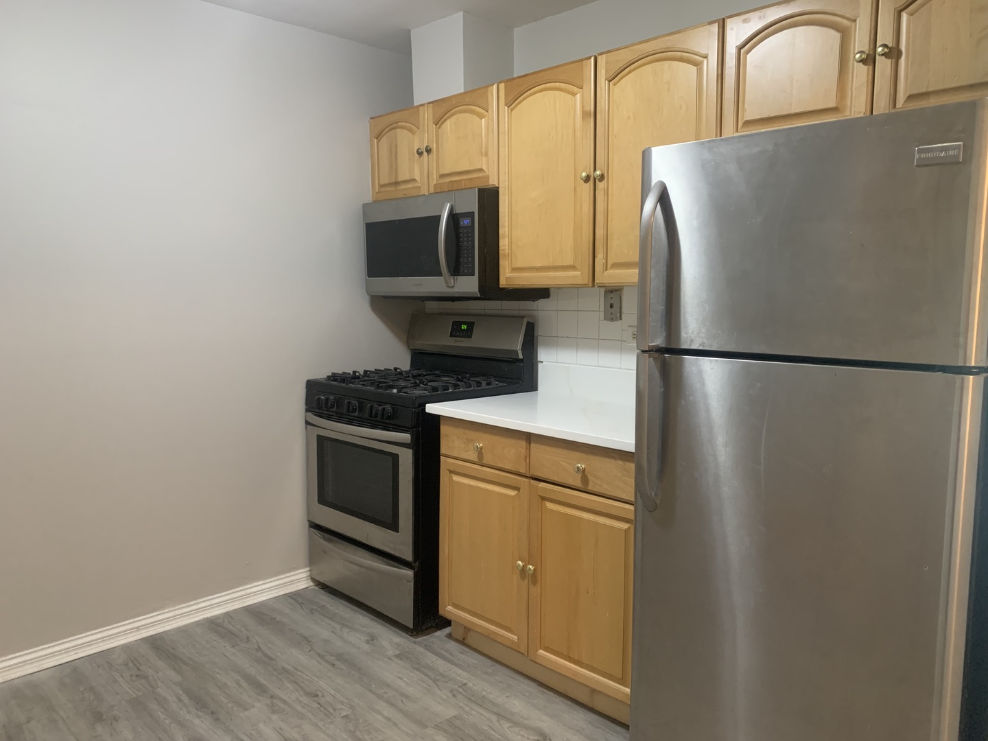 264 East Bailey Road, Unit L Naperville, IL 60565 - Photo 4 of 17 a white refrigerator freezer and a stove sitting inside of a kitchen