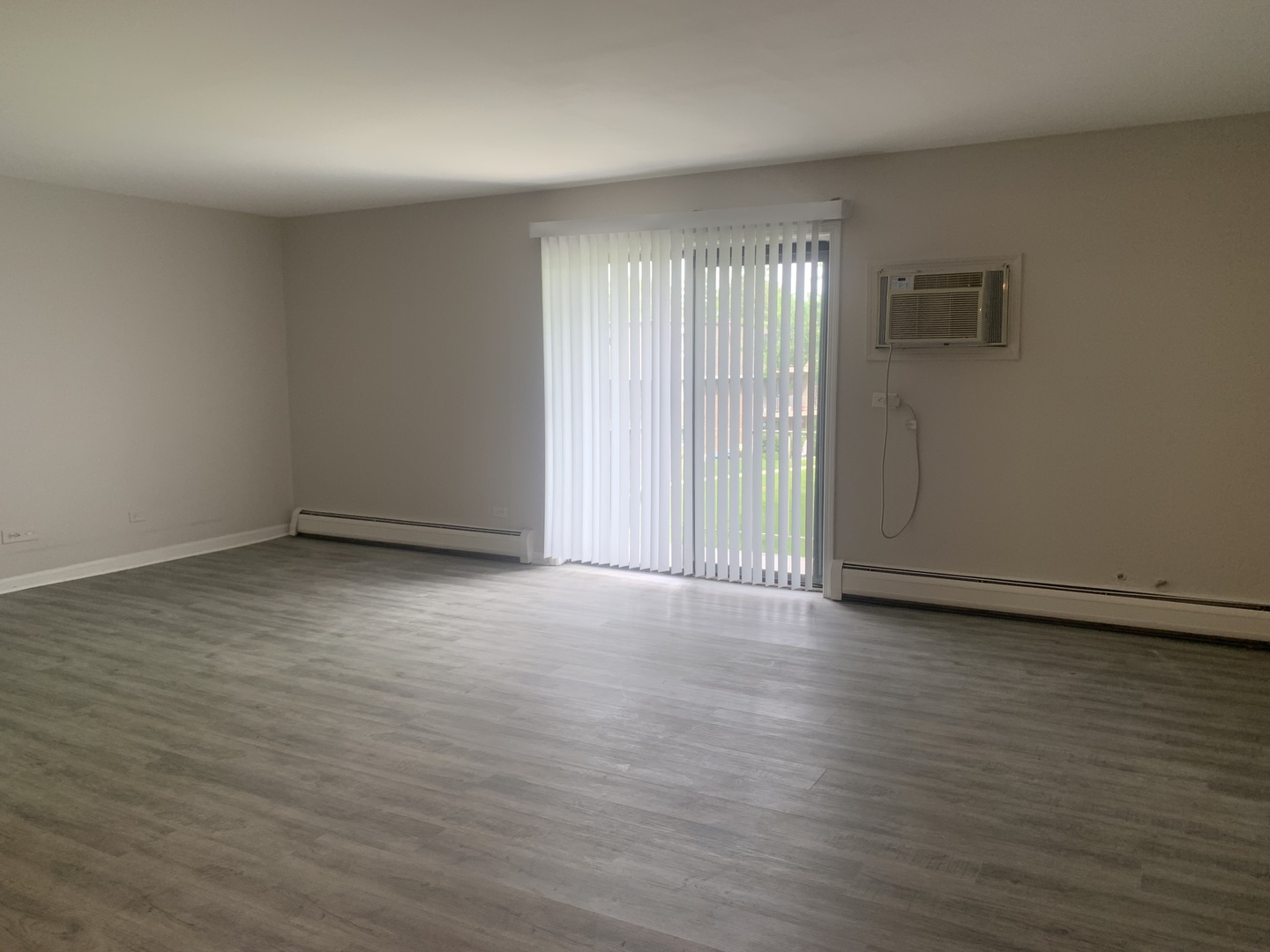 264 East Bailey Road, Unit L Naperville, IL 60565 - Photo 7 of 17 a view of an empty room with wooden floor and a window