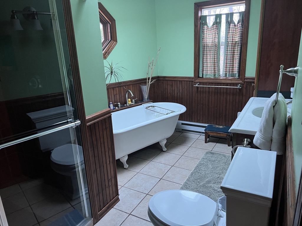 137 Warwick Road, Unit 137 Newton, MA 02465 - Photo 8 of 8 a bathroom with a sink toilet mirror and tub