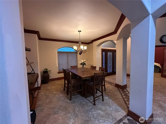 a dining room with furniture and chandelier