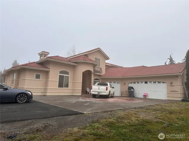 a view of a house with a wooden fence