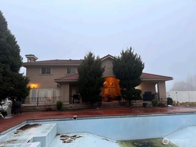 a view of a house and a yard fire pit and furniture