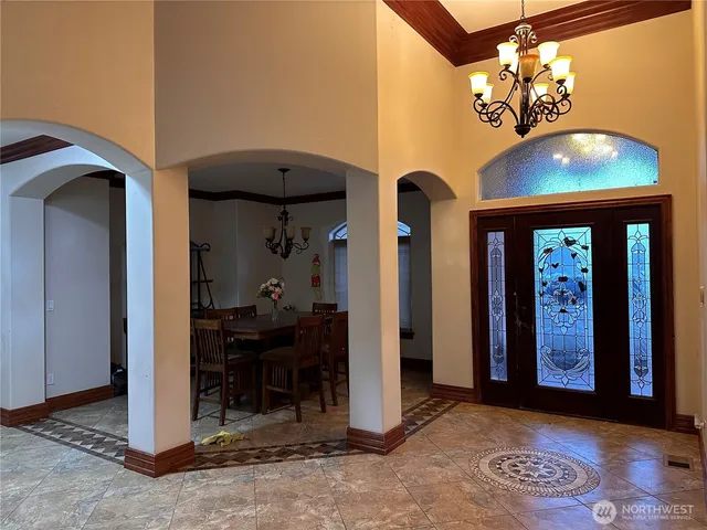 a living room with fireplace and a rug
