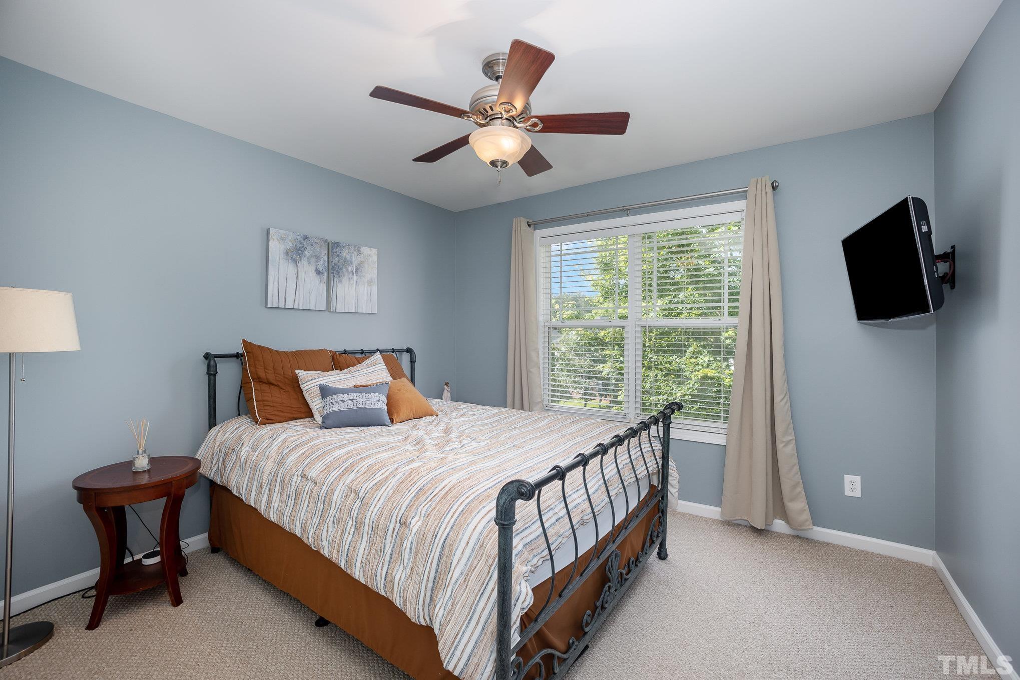 8404 Dunnington Circle Raleigh, NC 27613 - Photo 18 of 28 a bedroom with a bed and a flat screen tv