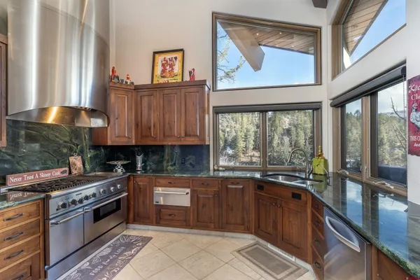 a living room with fireplace furniture and a floor to ceiling window