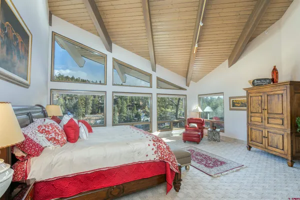 a bedroom with a bed and a large window
