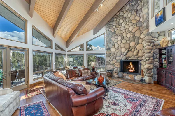 a living room with furniture a fireplace and a large window