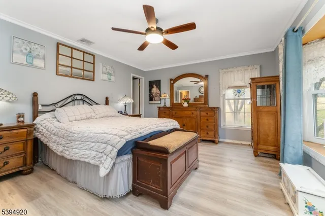 a bedroom with a bed and dresser with mirror