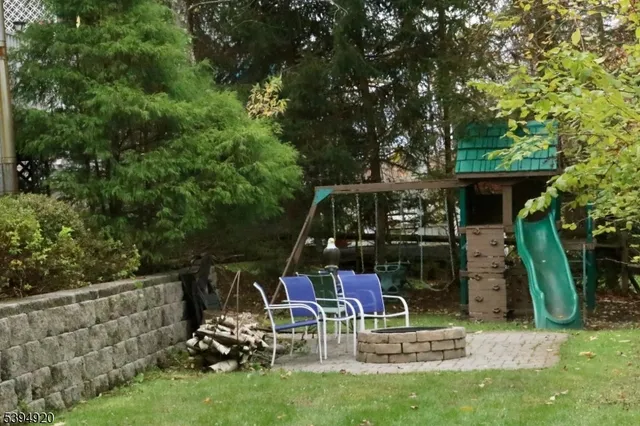 a view of a chair and tables in the backyard