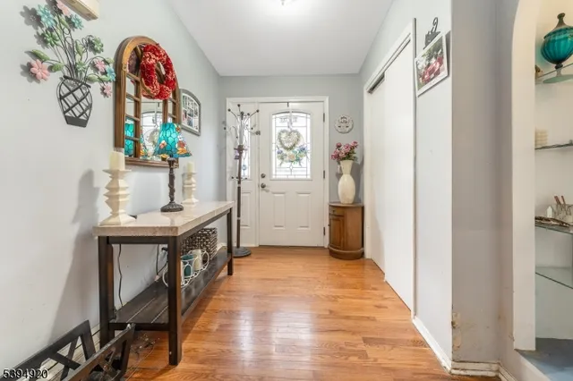 a view of entryway with furniture and wooden floor