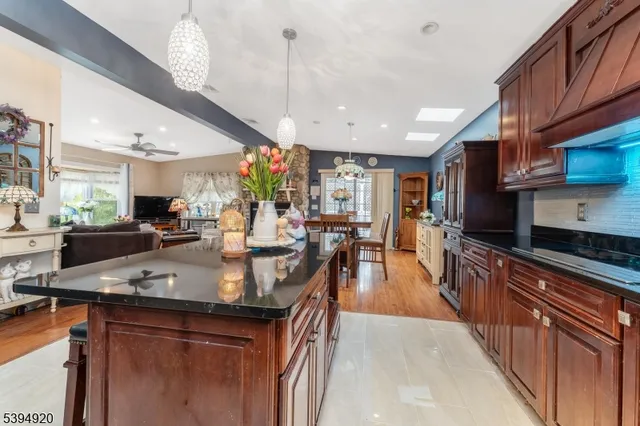 a kitchen with stainless steel appliances granite countertop a sink a counter space and cabinets