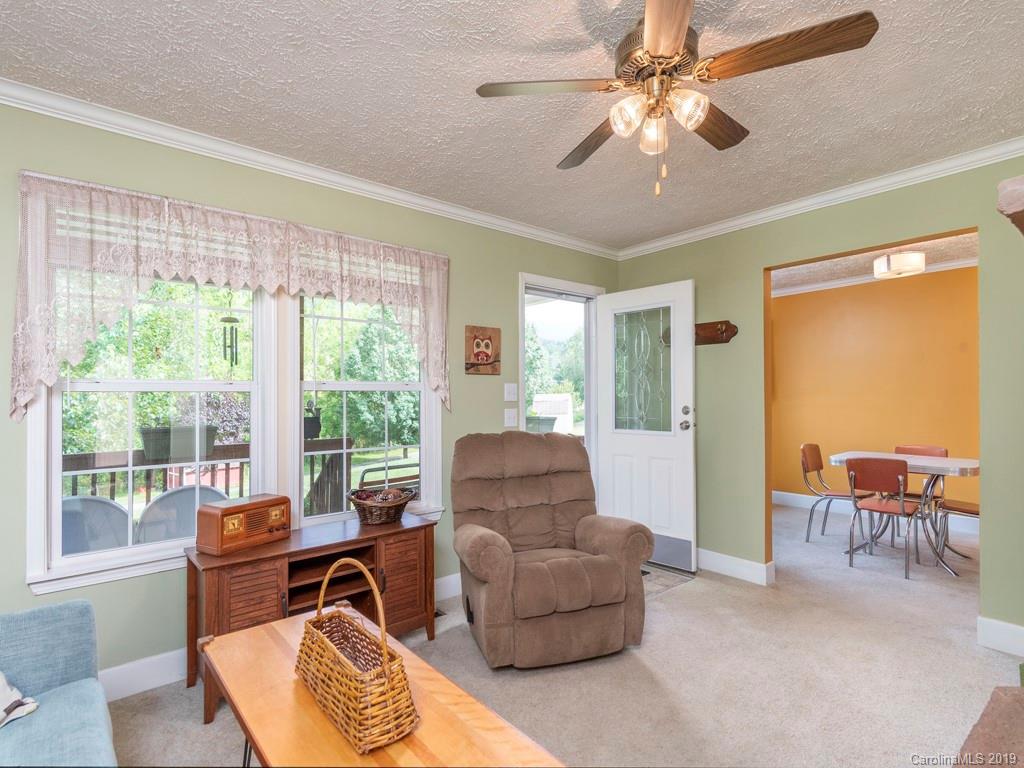 2488 Thickety Road Clyde, NC 28721 - Photo 2 of 25 a living room with furniture and a floor to ceiling window