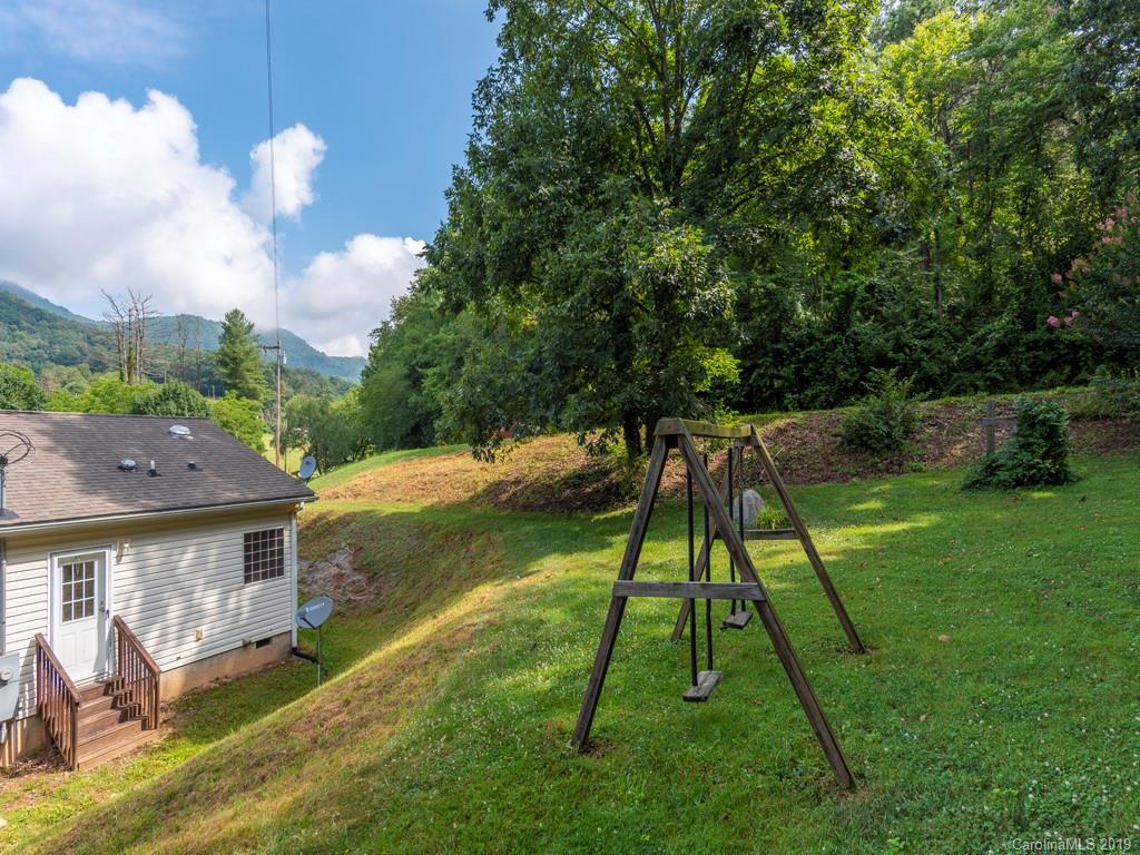 2488 Thickety Road Clyde, NC 28721 - Photo 17 of 25 a backyard of a house with table and chairs