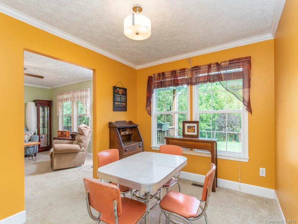 2488 Thickety Road Clyde, NC 28721 - Photo 3 of 25 a living room with furniture a fireplace and a large window
