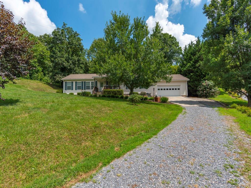 2488 Thickety Road Clyde, NC 28721 - Photo 22 of 25 a view of a house with garden and trees