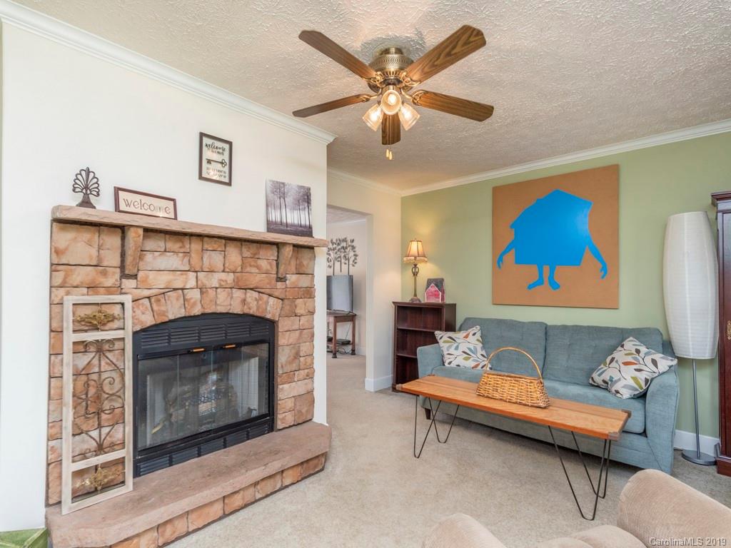 2488 Thickety Road Clyde, NC 28721 - Photo 4 of 25 a living room with furniture and a fireplace