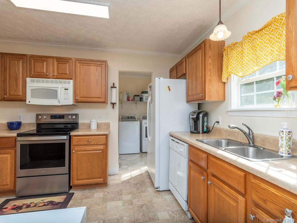 2488 Thickety Road Clyde, NC 28721 - Photo 5 of 25 a kitchen with a sink stove and refrigerator