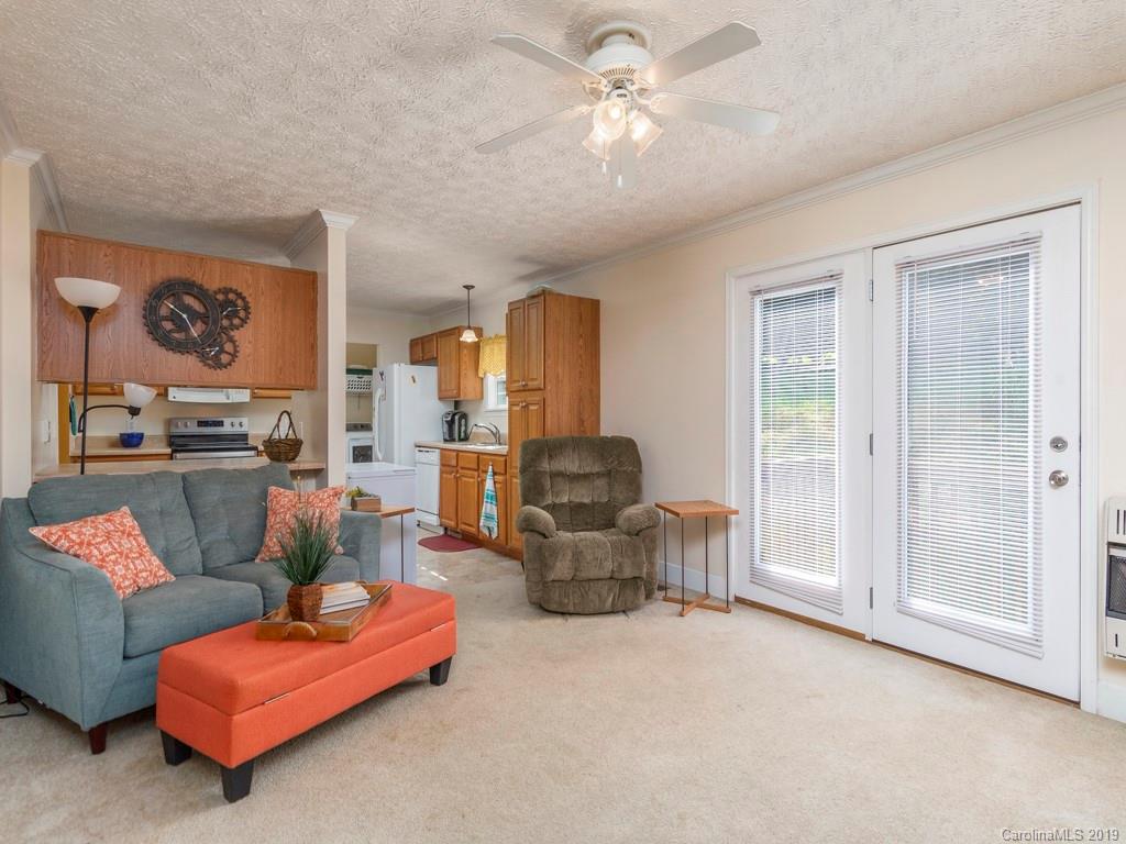2488 Thickety Road Clyde, NC 28721 - Photo 9 of 25 a living room with furniture and a chandelier