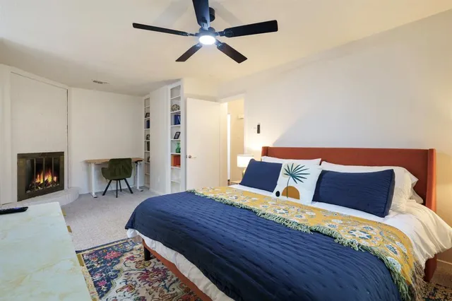 a bedroom with a bed and a fireplace