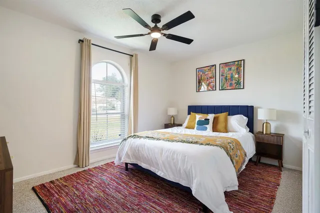 a bedroom with a large bed and a window