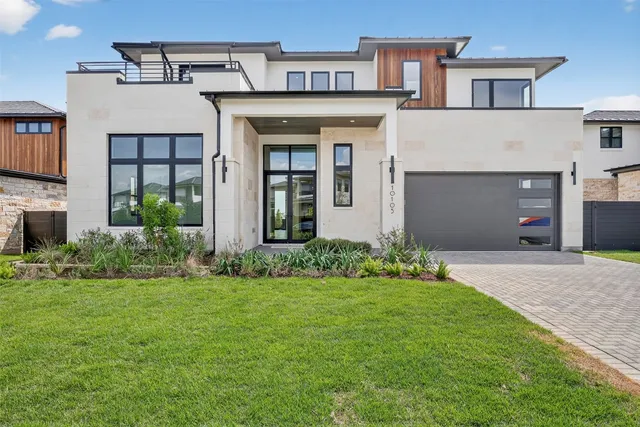 a front view of a house with a yard and garage
