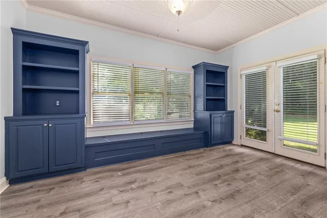 a view of an empty room with a window and cabinet