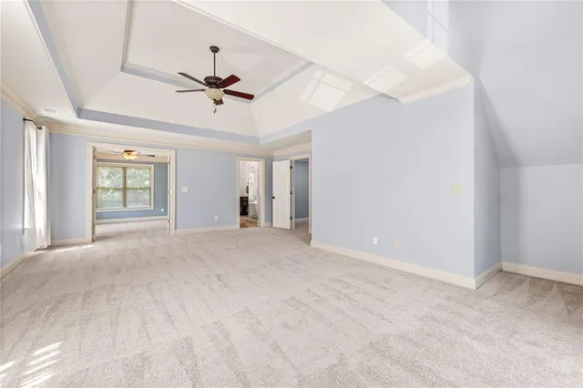 a view of a livingroom with a ceiling fan and window