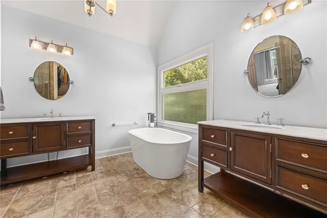 a bathroom with a sink double vanity and a mirror