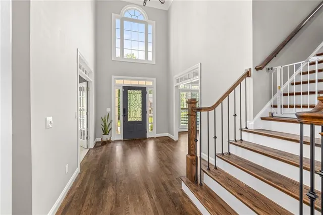 a view of an entryway with wooden floor and stairs