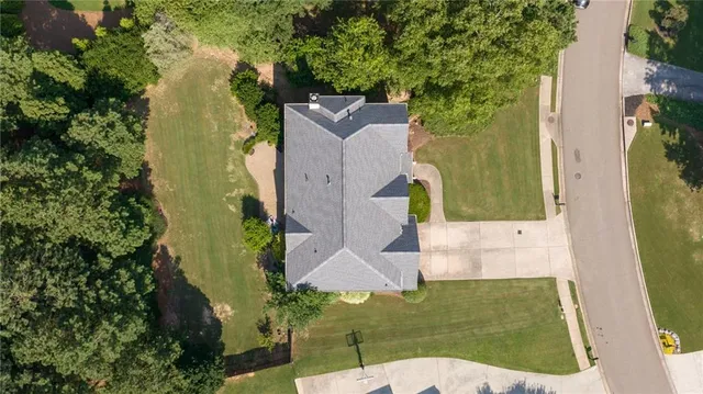 an aerial view of a house with a yard