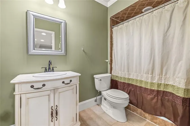 a bathroom with a toilet a sink and a mirror