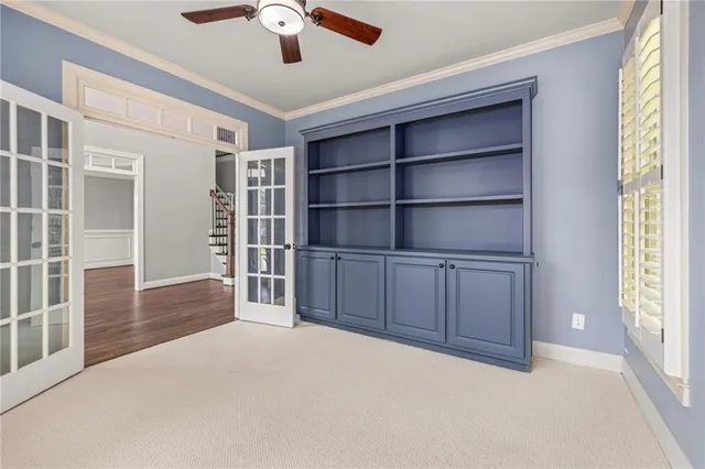 a view of an empty room with a window and cabinet