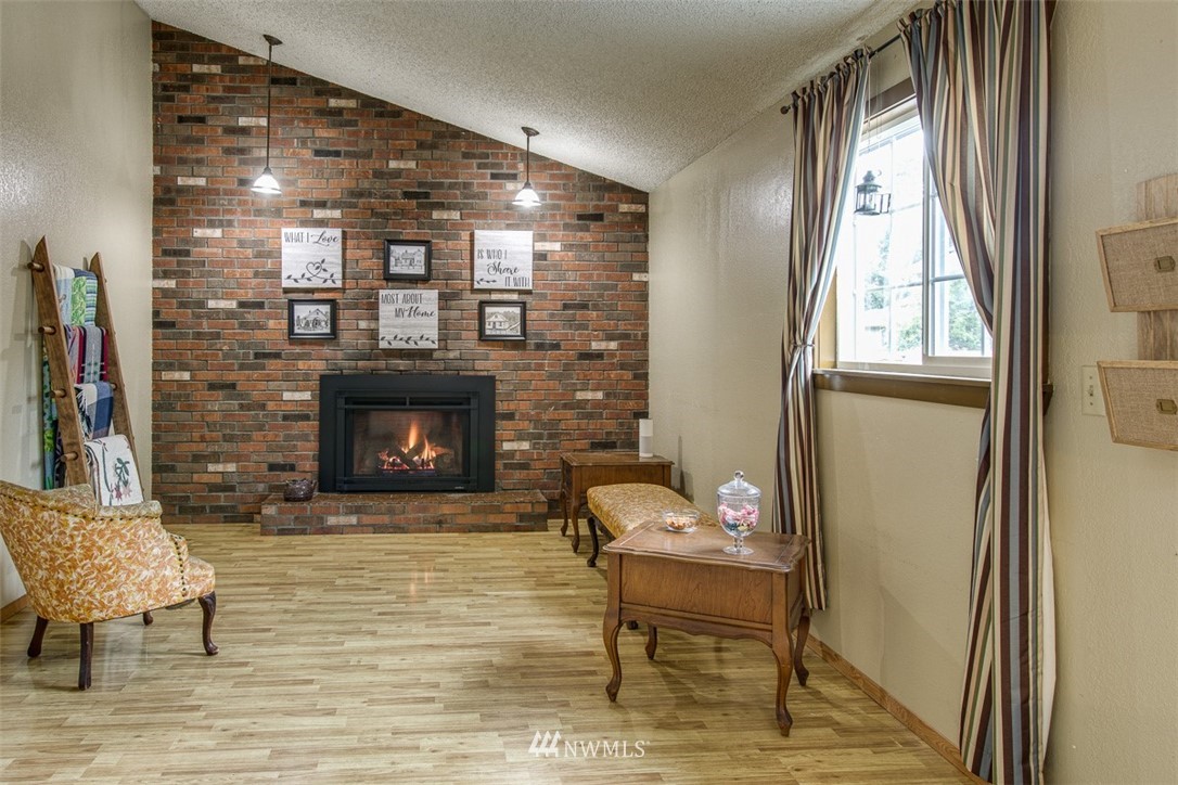3776 Magrath Road Bellingham, WA 98226 - Photo 11 of 23 a living room with furniture and a fireplace