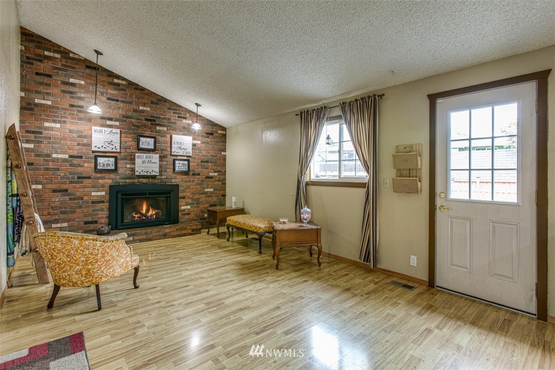 3776 Magrath Road Bellingham, WA 98226 - Photo 13 of 23 a living room with furniture and a fireplace