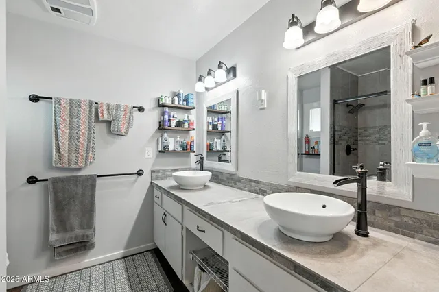 a spacious bathroom with a granite countertop sink and a mirror