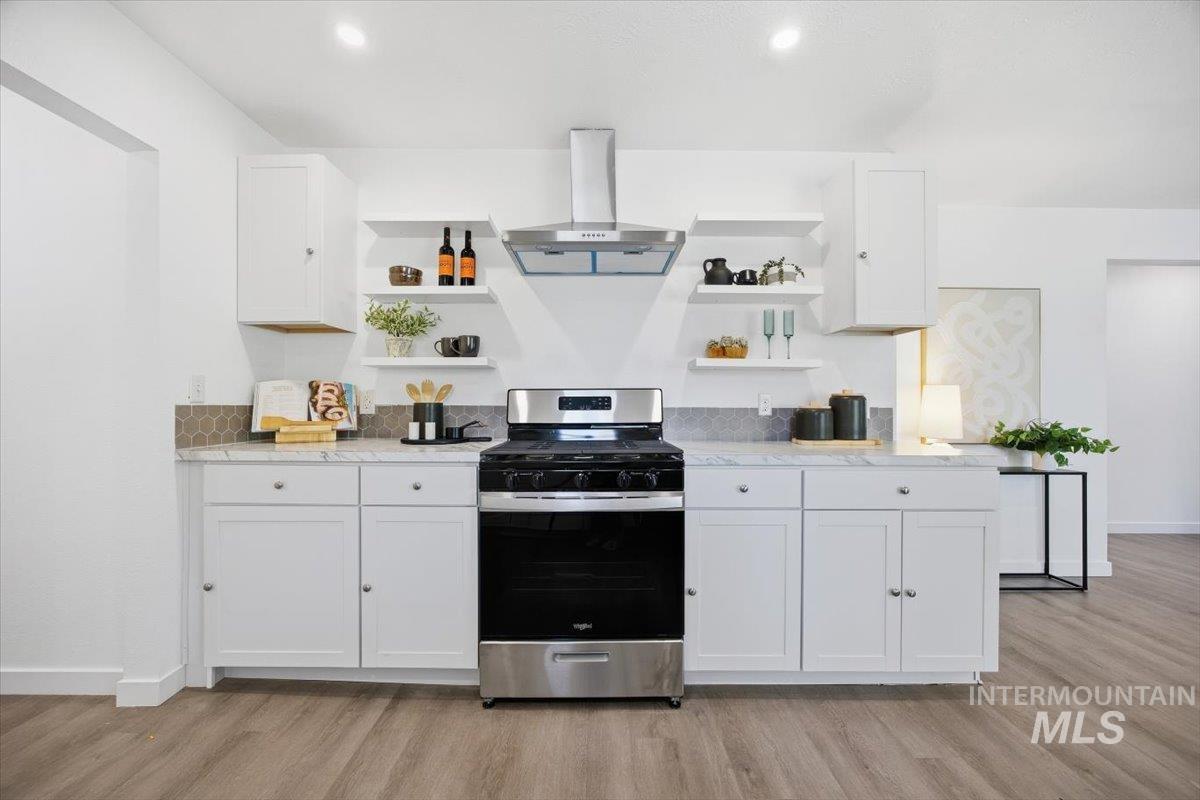1407 South Roosevelt Street Boise, ID 83705 - Photo 15 of 38 Kitchen with open shelves, white cabinets, stainless steel gas stove, exhaust hood, and light stone countertops