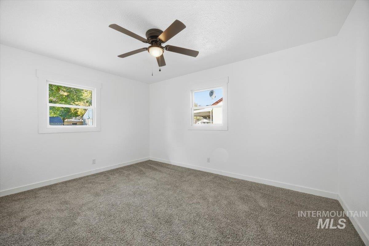 1407 South Roosevelt Street Boise, ID 83705 - Photo 32 of 38 Empty room with carpet, a textured ceiling, and a ceiling fan