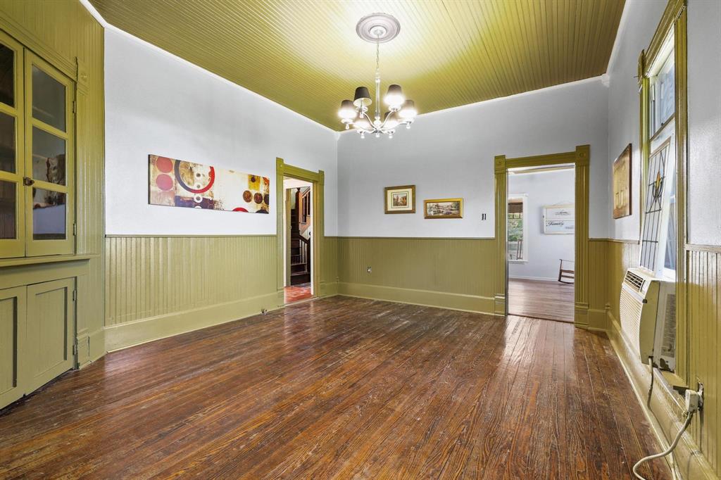 4453 Farm To Market 902 Howe, TX 75459 - Photo 14 of 40 Spacious interior with rich wood flooring, beadboard wainscoting, and a built-in corner cabinet