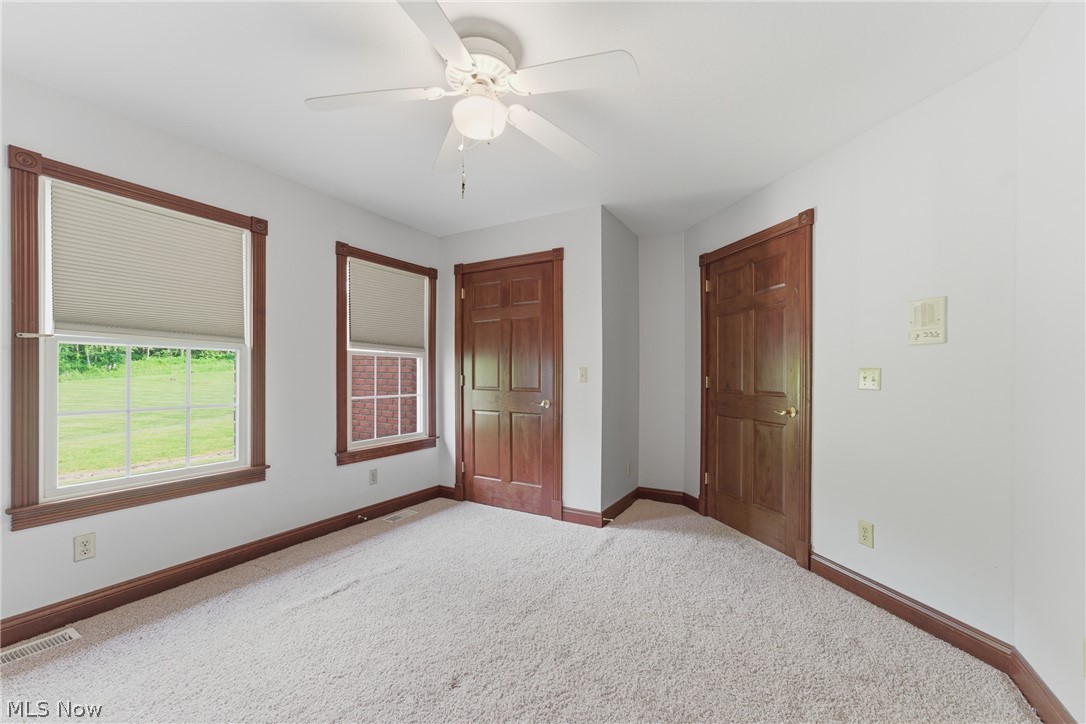 2184 Brenner Road Northeast Carrollton, OH 44615 - Photo 34 of 50 Carpeted interior space featuring white walls and a ceiling fan with integrated lighting