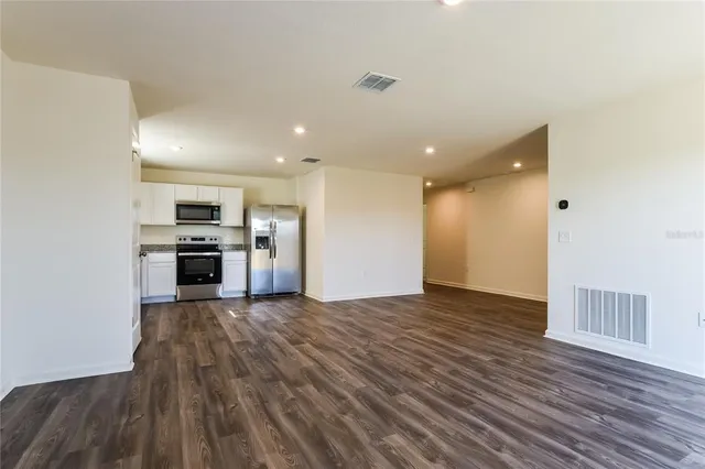 a view of kitchen view wooden floor and electronic appliances