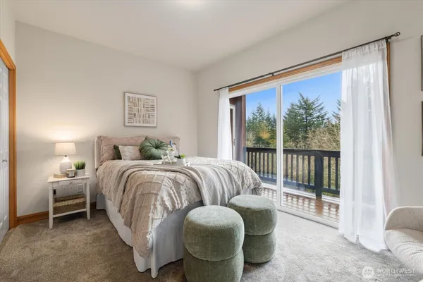 a bedroom with a bed and a large window