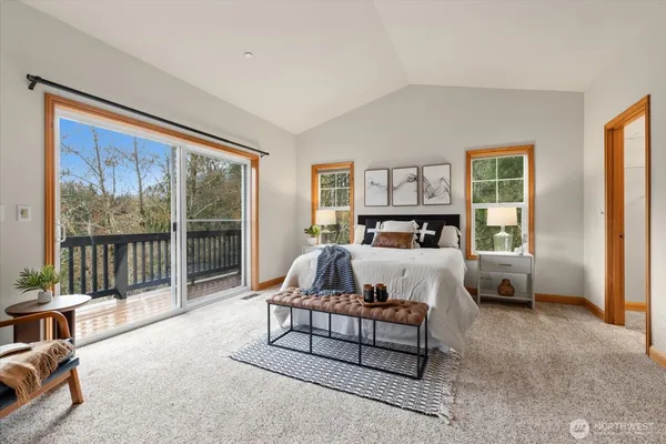 a bed room with couch and a window