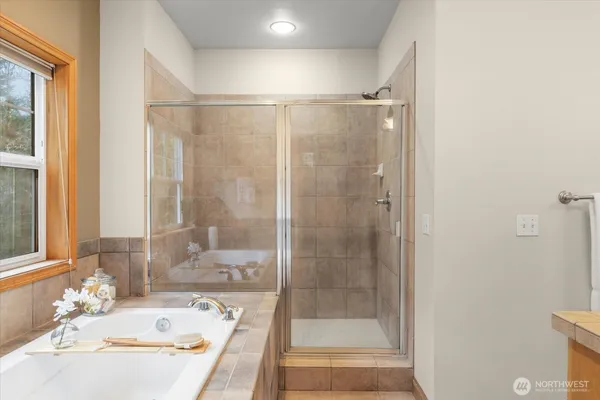 a bathroom with a tub and shower