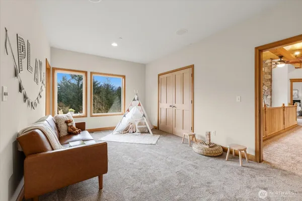 a living room with furniture and a floor to ceiling window