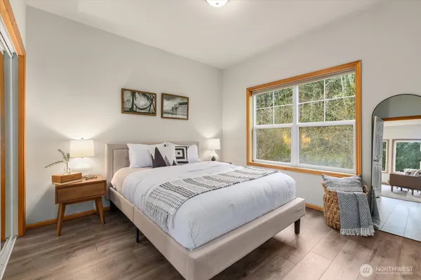 a bedroom with a bed and a large window