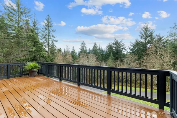 a view of balcony with wooden floor and fence
