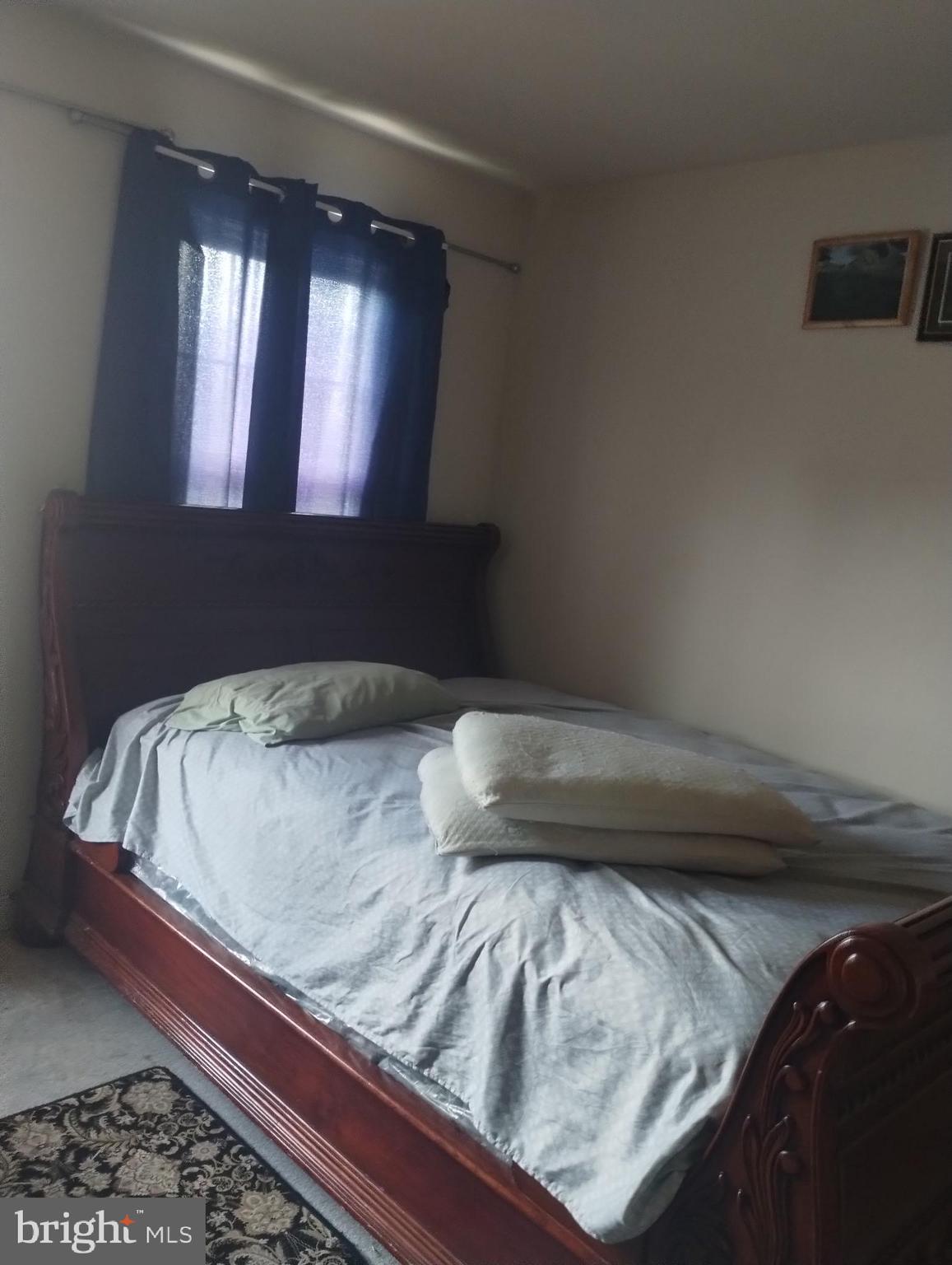 5100 Denmar Lane Bowie, MD 20720 - Photo 1 of 2 a bedroom with a bed and window