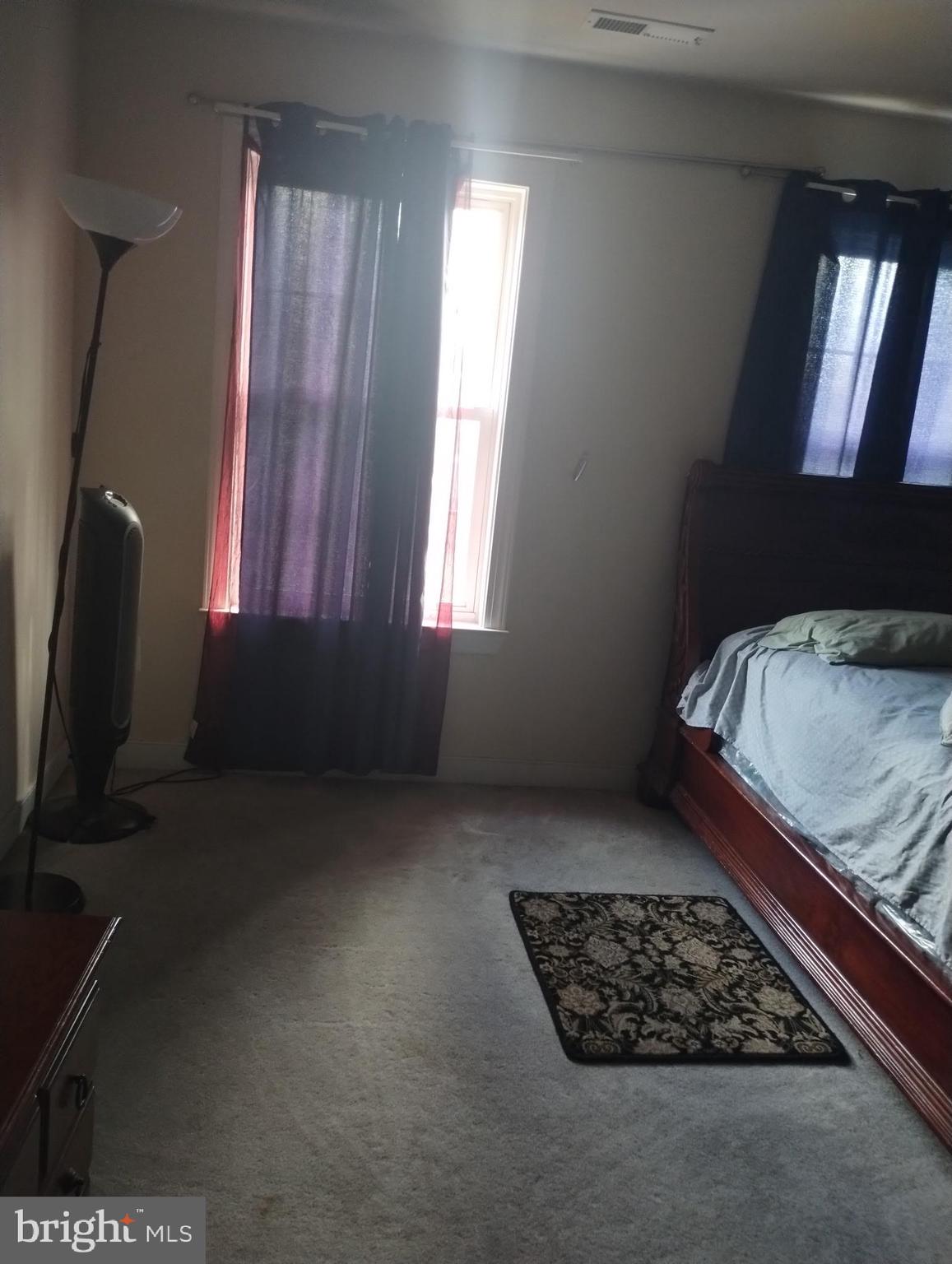 5100 Denmar Lane Bowie, MD 20720 - Photo 2 of 2 a bed sitting in a room next to a window
