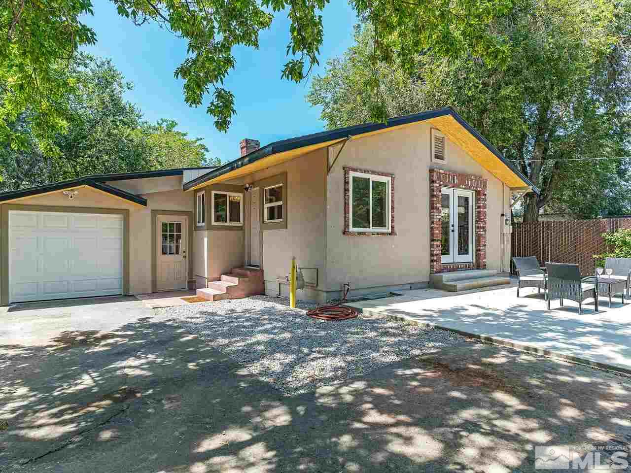 1409 Locust Street Reno, NV 89502 - Photo 13 of 16 a backyard of a house with table and chairs under an umbrella