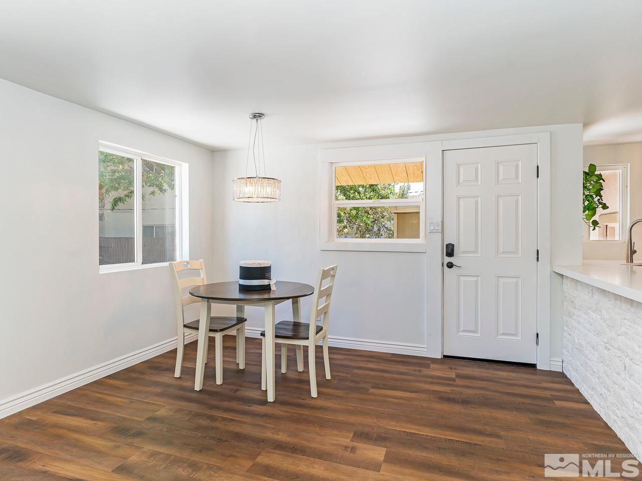 1409 Locust Street Reno, NV 89502 - Photo 5 of 16 a dining room with furniture a window and wooden floor